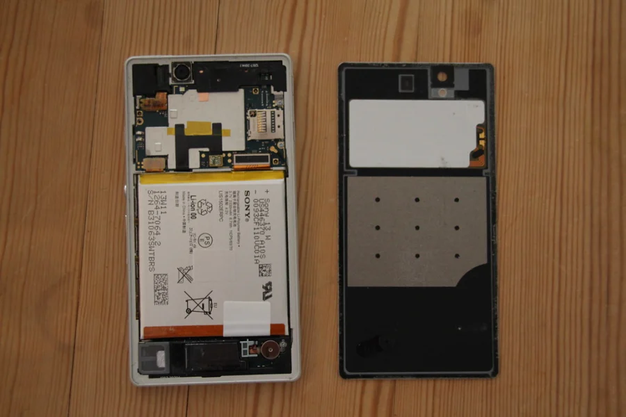Smartphone ouvert, coque arrière retirée, prêt pour une réparation